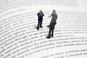 洋書の上で議論するビジネスマン
