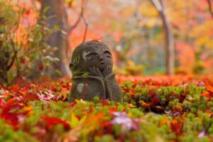 紅葉の中で微笑むお地蔵様